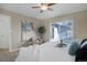 Relaxing bedroom featuring sliding glass doors, a cozy chair, and stylish artwork at 8487 Everett Way # E, Arvada, CO 80005