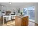 Bright dining area with a fireplace and white dining table near a kitchen island and sliding glass doors at 8487 Everett Way # E, Arvada, CO 80005