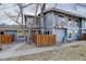 Charming two-story townhouse with a small fenced yard and mature tree, providing privacy and curb appeal at 8487 Everett Way # E, Arvada, CO 80005