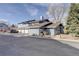 Blue townhomes with attached garages and well-kept landscaping at 8487 Everett Way # E, Arvada, CO 80005
