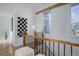 Bright stairway area with wooden railing and modern art at 8487 Everett Way # E, Arvada, CO 80005