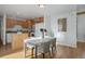 Bright and airy dining area adjacent to the kitchen, featuring hardwood floors and modern white and wood accents at 8487 Everett Way # E, Arvada, CO 80005
