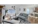 Bright living room with modern furnishings, large window, and neutral color palette, offering a relaxing ambiance at 8487 Everett Way # E, Arvada, CO 80005