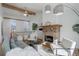 Cozy living room featuring a fireplace, wooden beams, and comfortable seating with soft textures and elegant décor at 8487 Everett Way # E, Arvada, CO 80005