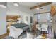 Open concept living area flowing into the kitchen, with hardwood floors, a fireplace, and stylish contemporary furniture at 8487 Everett Way # E, Arvada, CO 80005
