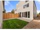 Backyard featuring a well maintained lawn, privacy fence, and concrete patio at 4570 N Raleigh St, Denver, CO 80212