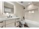 Modern bathroom featuring a sleek vanity, LED mirror, and a tub with stylish black fixtures at 4570 N Raleigh St, Denver, CO 80212