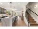 Open-concept kitchen with quartz island, modern fixtures, and a seamless transition to the living spaces at 4570 N Raleigh St, Denver, CO 80212
