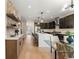 Modern kitchen with dark cabinetry, a quartz island, and open layout with dining and living areas at 4570 N Raleigh St, Denver, CO 80212