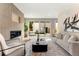 Cozy living room with a modern fireplace, stylish decor, and sliding doors to outdoor space at 4570 N Raleigh St, Denver, CO 80212