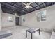 Unfinished basement space with concrete flooring, exposed ceiling, and natural light at 5174 Dudley St, Arvada, CO 80002