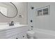 Renovated bathroom with white vanity, modern fixtures, and tiled shower at 5174 Dudley St, Arvada, CO 80002