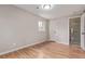 Bedroom featuring hardwood floors, a window, and an en-suite bathroom at 5174 Dudley St, Arvada, CO 80002