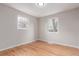 Bright bedroom featuring hardwood floors and windows offering natural light at 5174 Dudley St, Arvada, CO 80002