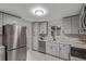 Modern kitchen with stainless steel appliances, light gray cabinetry, and ample counter space at 5174 Dudley St, Arvada, CO 80002