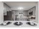 Bright, updated kitchen with stainless appliances, grey cabinets and countertops at 5174 Dudley St, Arvada, CO 80002