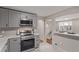 Well-appointed kitchen featuring stainless steel appliances and light gray cabinets at 5174 Dudley St, Arvada, CO 80002