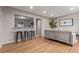 Living room showcasing hardwood floors, neutral paint, and a pass-through to the kitchen at 5174 Dudley St, Arvada, CO 80002