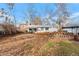 Backyard view with detached shed and mature trees at 6145 W 38Th Ave, Wheat Ridge, CO 80033