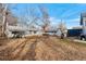 Large backyard with mature trees and detached structures at 6145 W 38Th Ave, Wheat Ridge, CO 80033