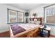 Cozy bedroom with wooden bed frame and large windows at 6145 W 38Th Ave, Wheat Ridge, CO 80033