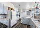 Retro kitchen features light blue cabinetry, mosaic backsplash, and updated flooring at 6145 W 38Th Ave, Wheat Ridge, CO 80033