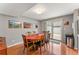 Dining room with hardwood floors, oval dining table, and sliding glass door to patio at 7114 E Briarwood Dr, Centennial, CO 80112