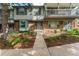 Two-story townhome with brick and siding exterior, landscaping, and a walkway at 7114 E Briarwood Dr, Centennial, CO 80112