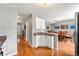 Kitchen with granite countertops and white cabinets, open to dining area at 7114 E Briarwood Dr, Centennial, CO 80112