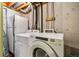 Basement laundry room with washer, dryer and refrigerator at 7114 E Briarwood Dr, Centennial, CO 80112