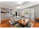 Living room with hardwood floors, sectional sofa, and a coffee table at 7114 E Briarwood Dr, Centennial, CO 80112