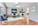 Bright living room with hardwood floors, fireplace, and neutral paint, perfect for entertaining guests at 7114 E Briarwood Dr, Centennial, CO 80112