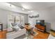 Living room with hardwood floors, bay window, and comfortable seating area at 7114 E Briarwood Dr, Centennial, CO 80112