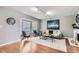 Bright living room featuring hardwood floors, bay window, fireplace, and modern decor at 7114 E Briarwood Dr, Centennial, CO 80112