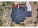 Detailed aerial view of the house, showing the roofline, landscaping, and surrounding rock ground cover at 9727 Red Primrose St, Franktown, CO 80116