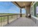 Relaxing outdoor deck with scenic views, featuring wood-like flooring and comfortable seating area, ready for entertaining at 9727 Red Primrose St, Franktown, CO 80116