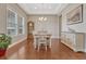 Bright dining room featuring hardwood floors, elegant chandelier, and large windows with natural light at 9727 Red Primrose St, Franktown, CO 80116