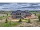 An aerial view showcases the home's architectural design and landscaped surroundings within a vibrant community at 9727 Red Primrose St, Franktown, CO 80116
