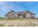 Gorgeous single story home with a combination of stone and gray siding, and a well-maintained front yard at 9727 Red Primrose St, Franktown, CO 80116