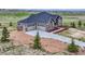 Stunning home with a three-car garage, stone accents, a concrete driveway, and professionally landscaped front yard at 9727 Red Primrose St, Franktown, CO 80116