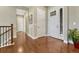 Elegant foyer with hardwood floors, white trim, and a view of the staircase and front door at 9727 Red Primrose St, Franktown, CO 80116