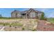 Charming front exterior with stone and siding accents, complemented by a well-manicured lawn and inviting curb appeal at 9727 Red Primrose St, Franktown, CO 80116