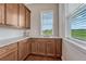 Butler's pantry area with ample counter space, custom cabinetry, and a bright window at 9727 Red Primrose St, Franktown, CO 80116