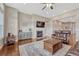 Comfortable living room with a fireplace, hardwood floors, and a ceiling fan for added comfort at 9727 Red Primrose St, Franktown, CO 80116