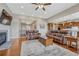 Open-concept living room featuring hardwood floors, a fireplace, and seamless flow to other living areas at 9727 Red Primrose St, Franktown, CO 80116