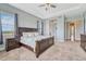 Serene primary bedroom with tray ceiling, large windows, and an en-suite bathroom at 9727 Red Primrose St, Franktown, CO 80116