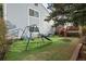 Fenced backyard with artificial turf, a playground, and a deck, perfect for outdoor activities at 17613 E Ohio Cir, Aurora, CO 80017