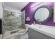 Bright bathroom featuring a stand up shower with stylish glass door, toilet, and vanity with unique mirror at 17613 E Ohio Cir, Aurora, CO 80017