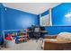 Comfortable bedroom offering ample space, bright blue walls, and a window view at 17613 E Ohio Cir, Aurora, CO 80017