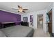 Spacious bedroom featuring plush carpet, ceiling fan, and en suite bathroom access at 17613 E Ohio Cir, Aurora, CO 80017